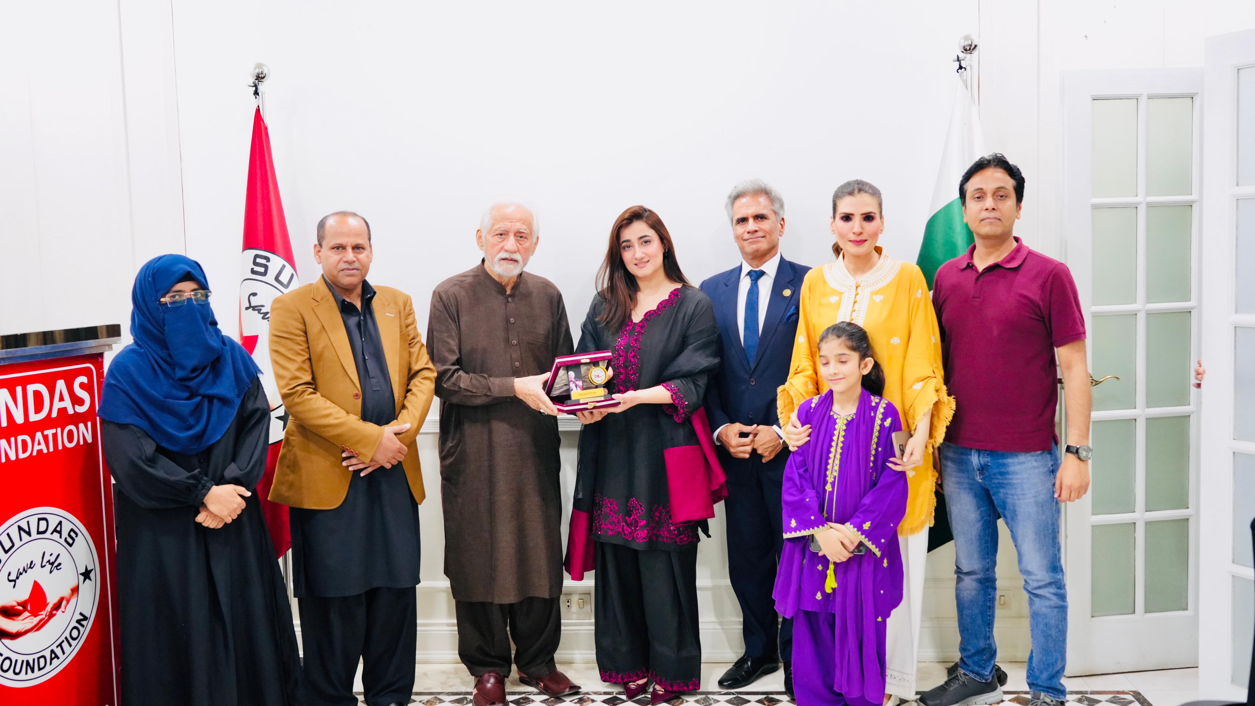 Film star Resham and singer Nimra Mehra interacting with children during their visit to Sundas Foundation in Lahore.